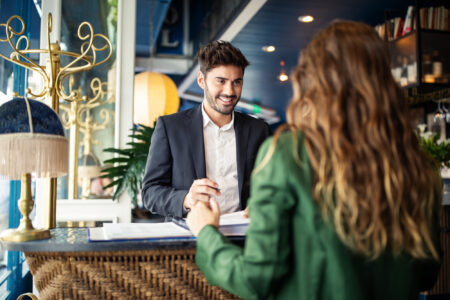 Concierge checking in a guest at a hotel