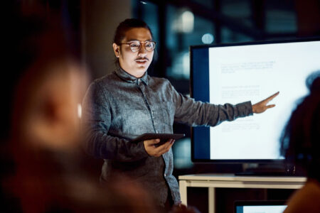 Man presenting a set of data in a meeting